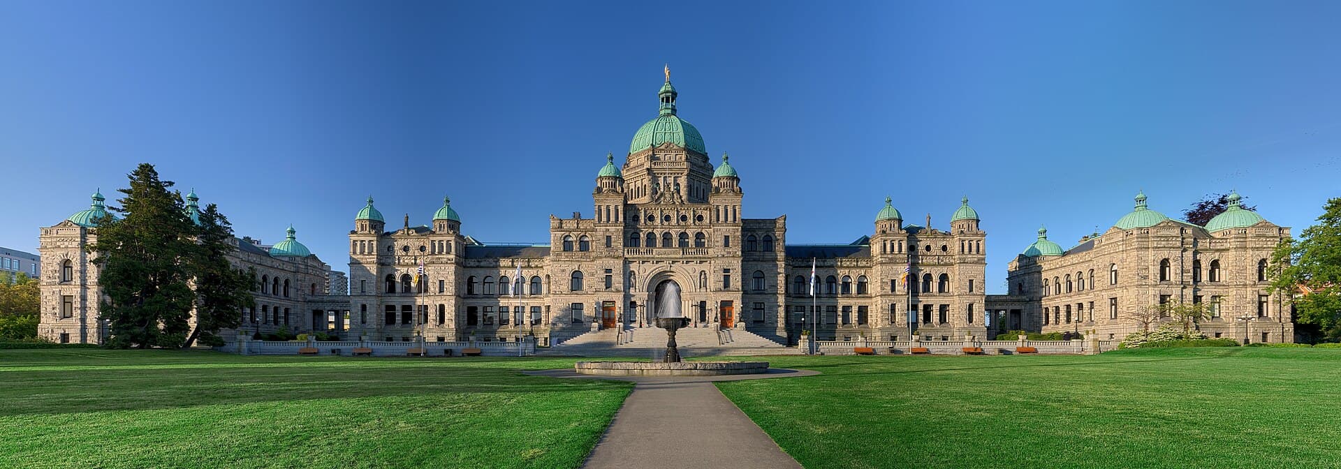 Victoria BC harbour and Parliament Buildings illuminated at dusk